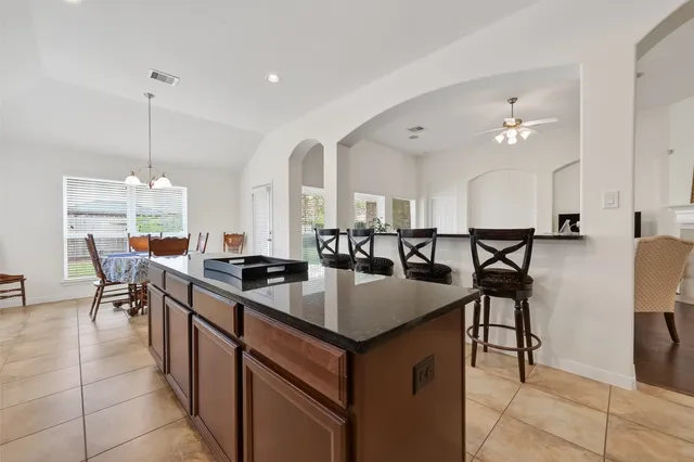 a kitchen with center island table and chairs