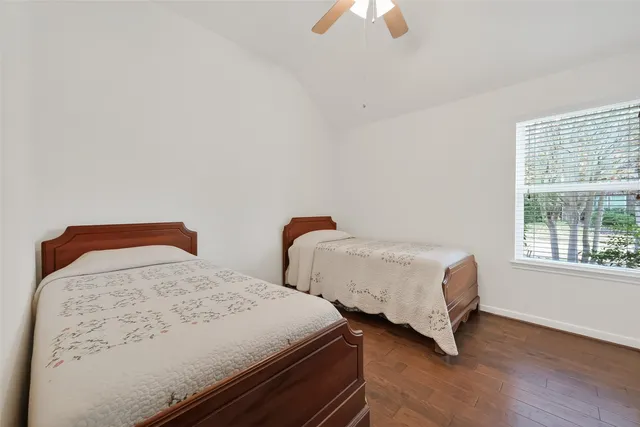 a bedroom with two beds and a window