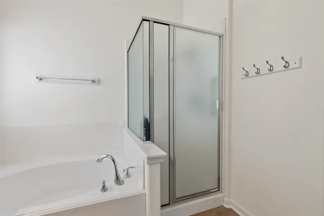 a bathroom with a bathtub and a shower