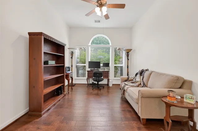 a living room with furniture a fireplace and a chandelier