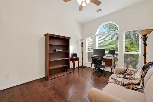 a view of a livingroom with workspace and a window