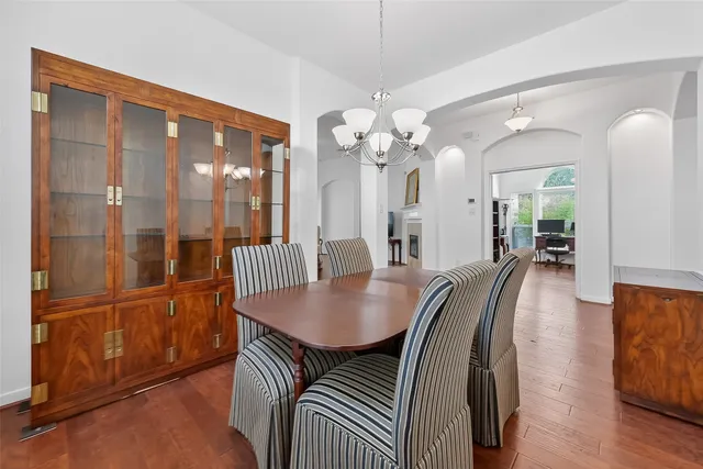 a view of a dining room with furniture wooden floor and chandelier