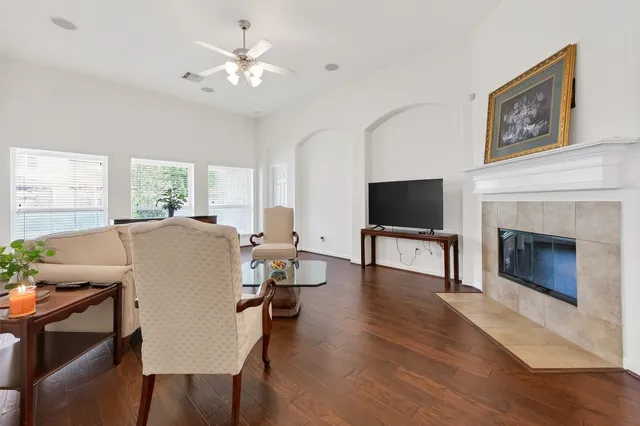 a living room with furniture a fireplace and a flat screen tv