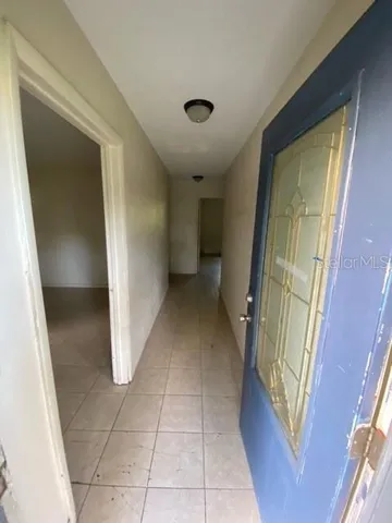 a view of entryway with kitchen and a sink