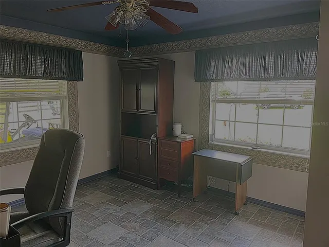 a living room with furniture and flowers