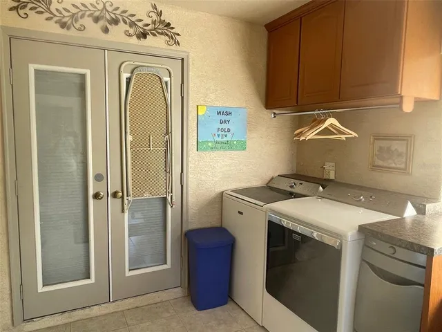 a kitchen with stainless steel appliances kitchen island granite countertop a table chairs in it and wooden floors