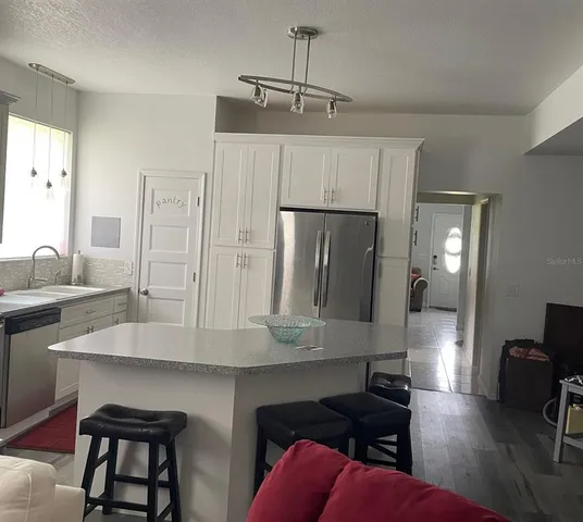 a large bedroom with a bed and a mirror