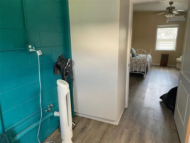 a view of a hallway to a livingroom with furniture