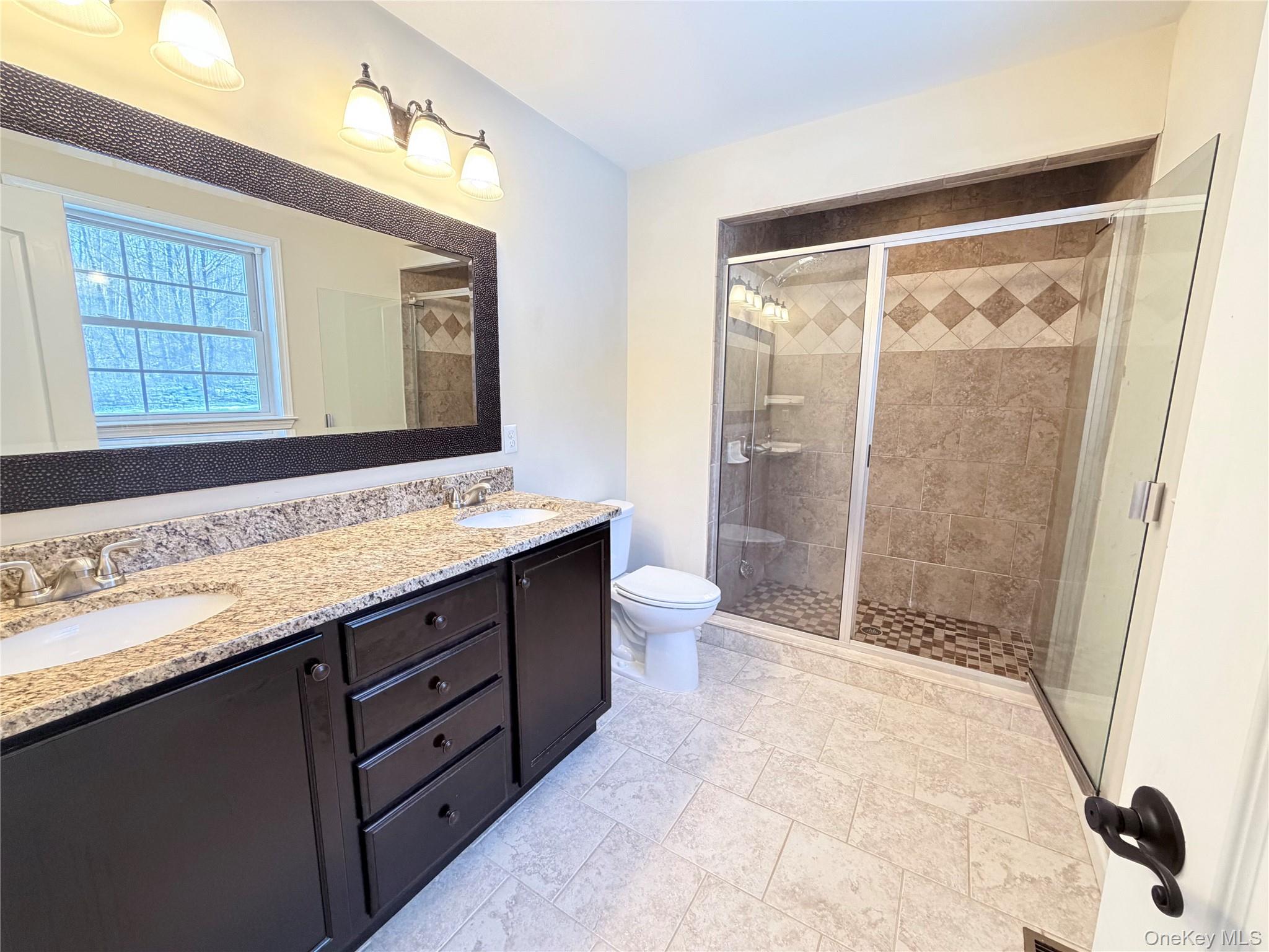 750 Mullock Road Port Jervis, NY 12771 - Photo 16 of 41 a bathroom with a granite countertop sink toilet and shower