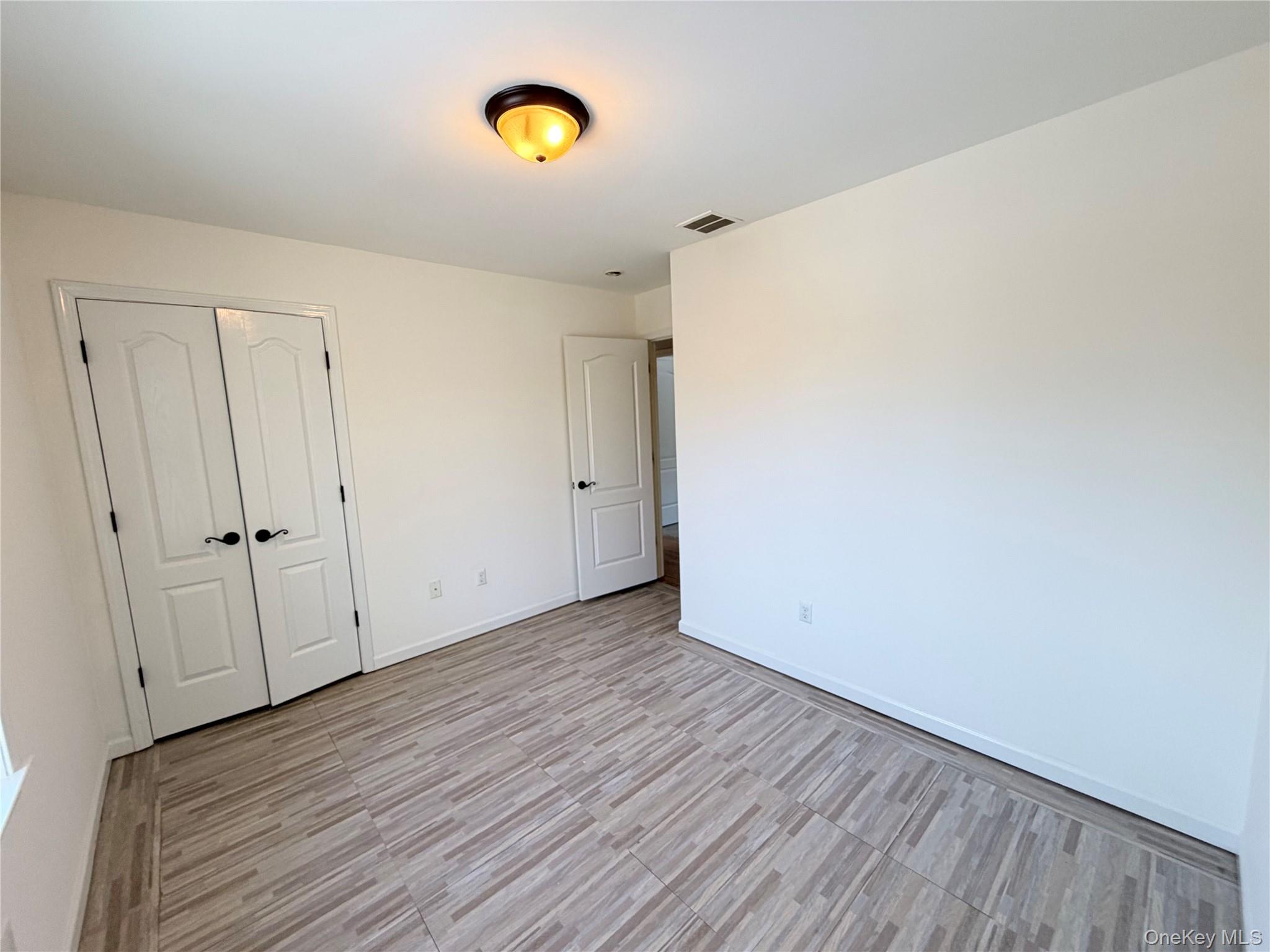 750 Mullock Road Port Jervis, NY 12771 - Photo 19 of 41 a view of an empty room with wooden floor and a window
