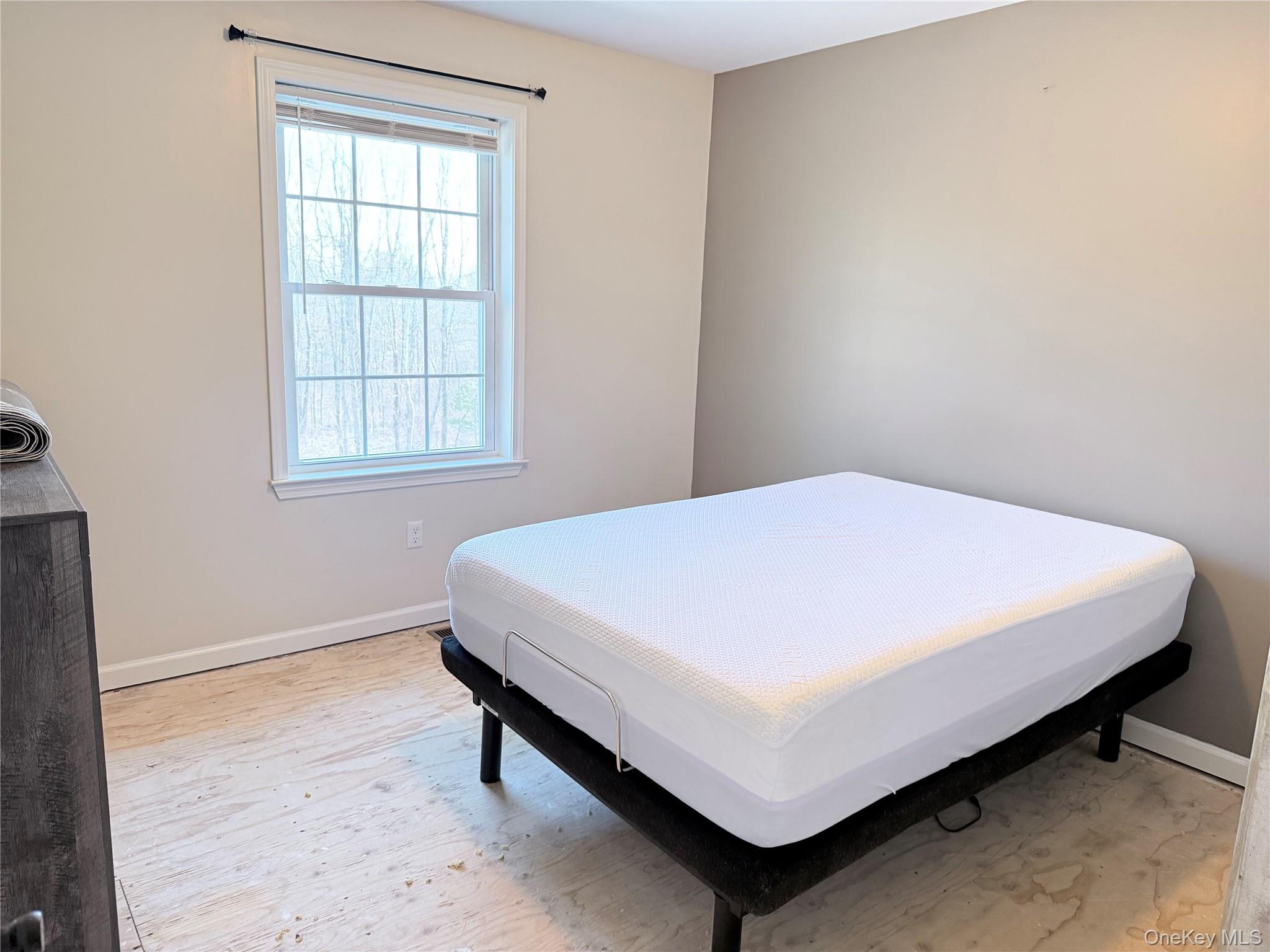 750 Mullock Road Port Jervis, NY 12771 - Photo 20 of 41 a bed sitting in a bedroom next to a window