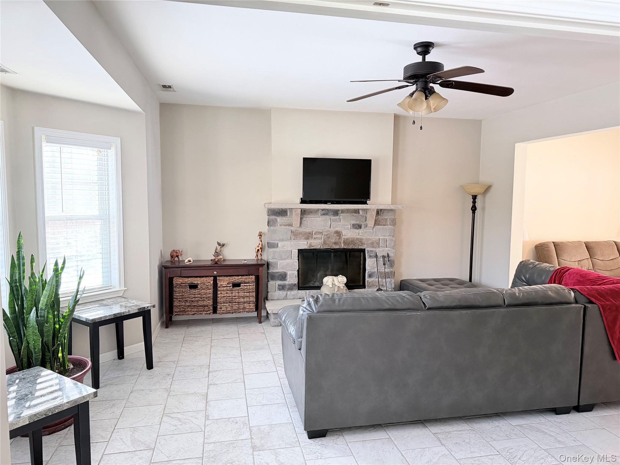 750 Mullock Road Port Jervis, NY 12771 - Photo 23 of 41 a living room with furniture a flat screen tv and a fireplace