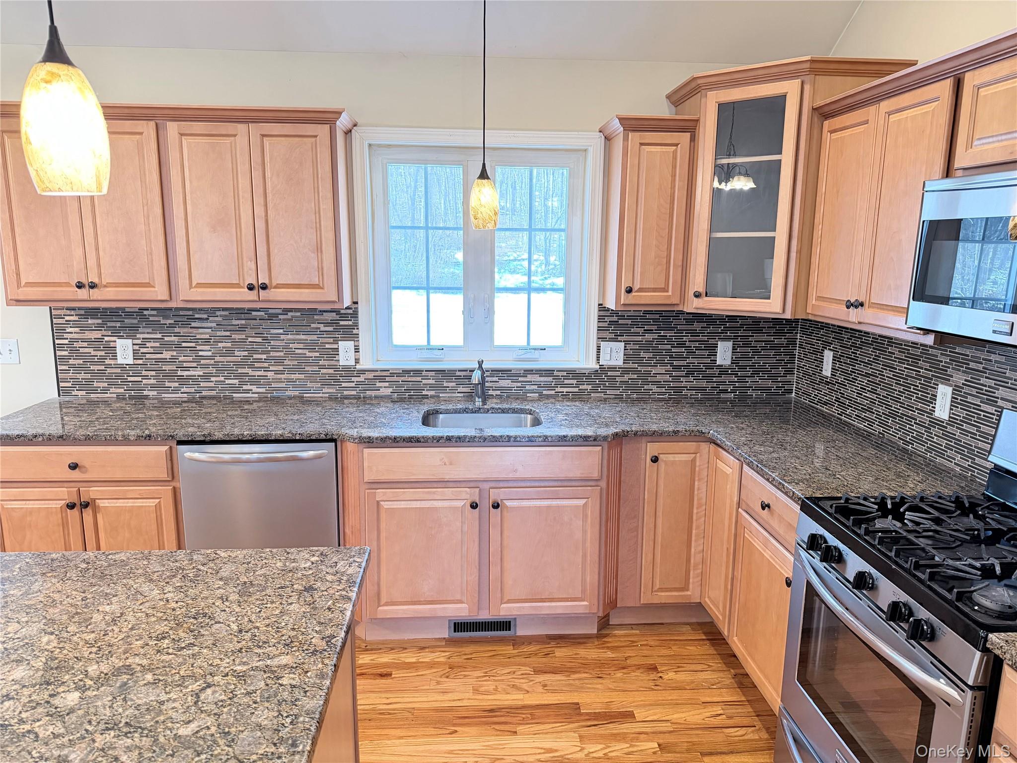 750 Mullock Road Port Jervis, NY 12771 - Photo 3 of 41 a kitchen with granite countertop a sink stove and cabinets