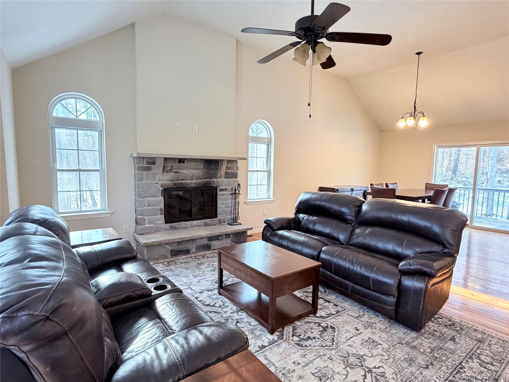 750 Mullock Road Port Jervis, NY 12771 - Photo 10 of 41 a living room with furniture ceiling fan and a fireplace