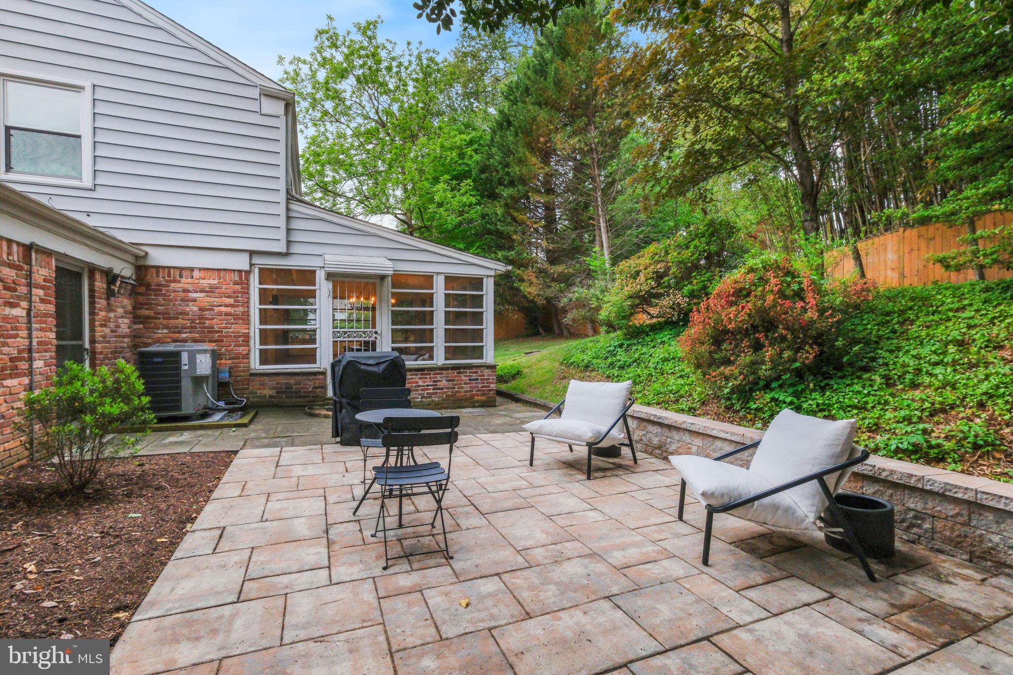 10900 Gainsborough Road Potomac, MD 20854 - Photo 2 of 44 a view of a patio with table and chairs and potted plants