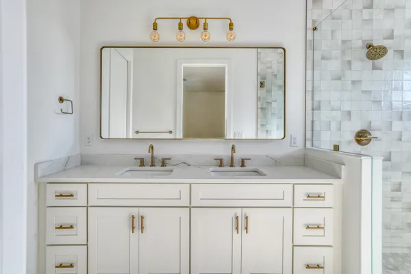 a bathroom with a sink vanity and a mirror