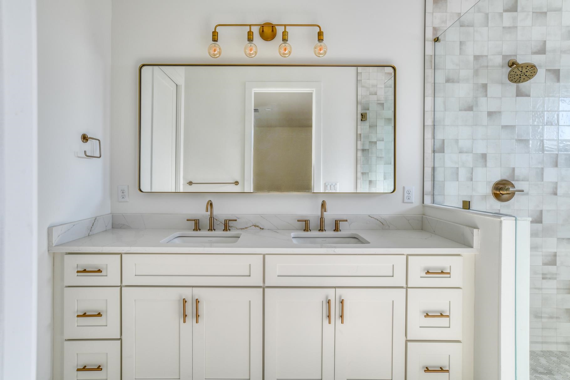 7 Sebastian Avenue, Unit D St. Augustine, FL 32084 - Photo 24 of 42 a bathroom with a sink vanity and a mirror