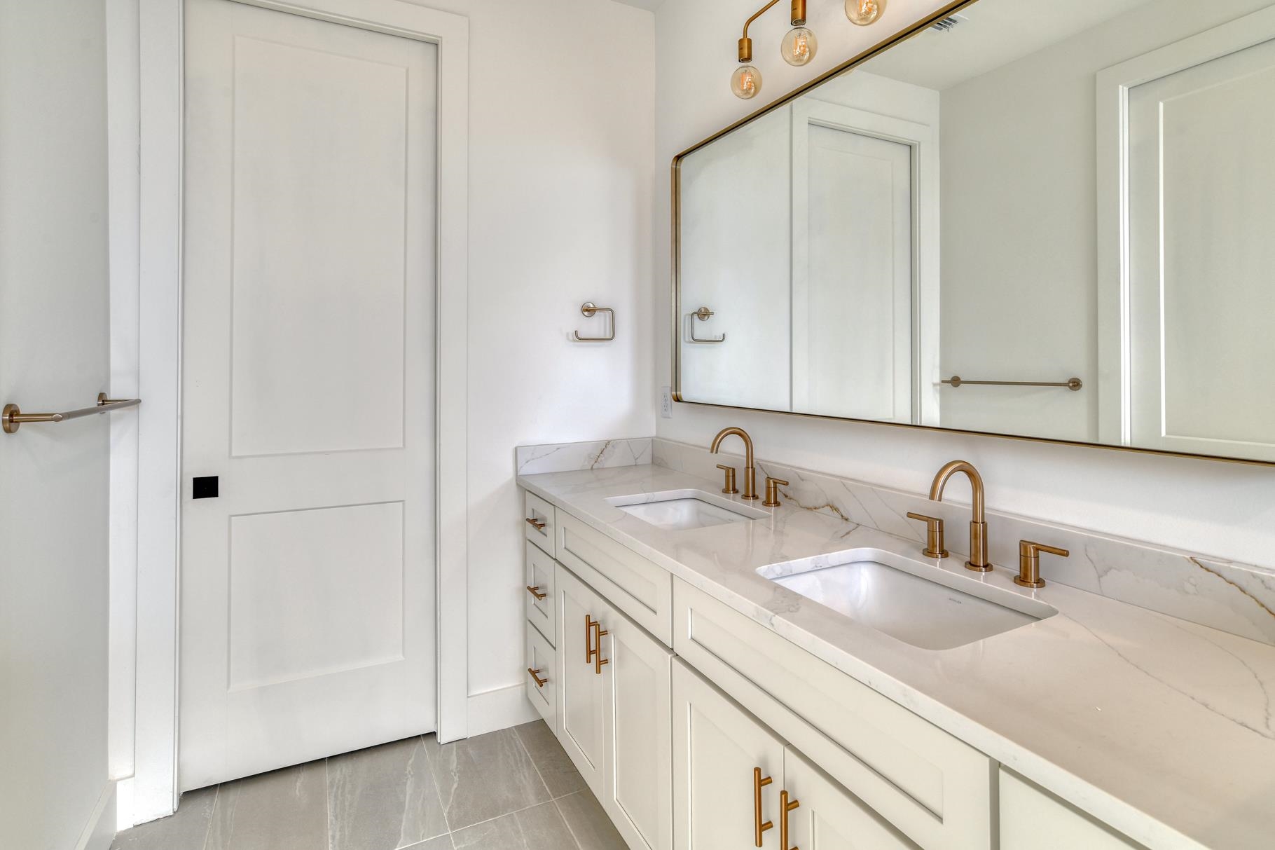 7 Sebastian Avenue, Unit D St. Augustine, FL 32084 - Photo 25 of 42 a bathroom with a sink and a mirror