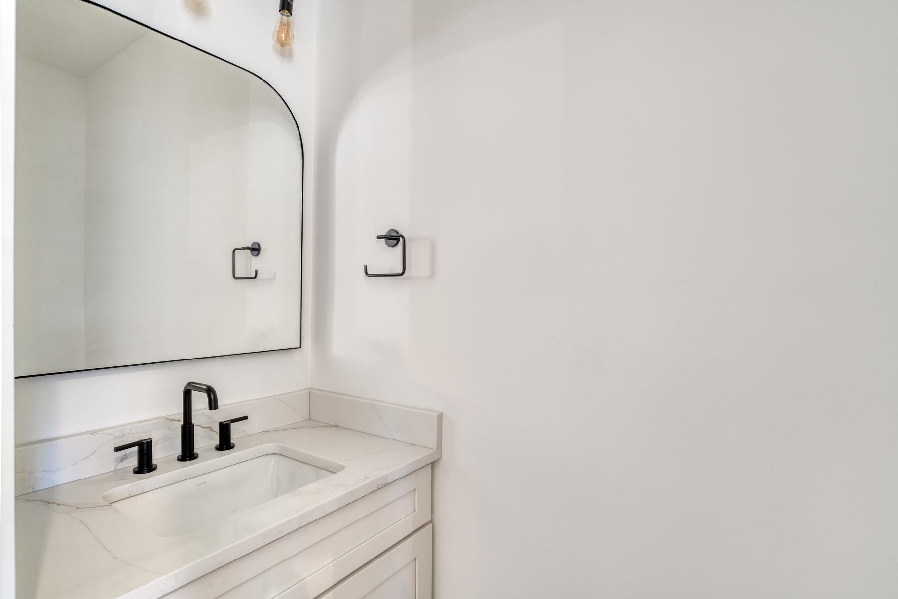 7 Sebastian Avenue, Unit D St. Augustine, FL 32084 - Photo 6 of 42 a bathroom with a sink and a mirror