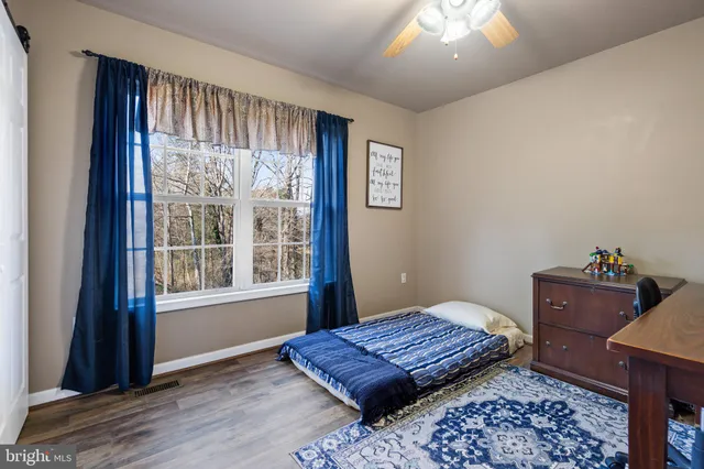 a bedroom with a large bed and a mirror