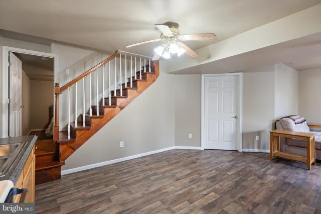 a hallway with a fireplace and wooden floor