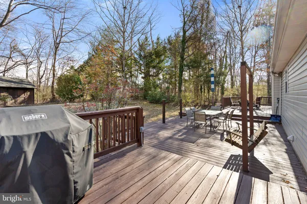 a view of a bench in the backyard of the house
