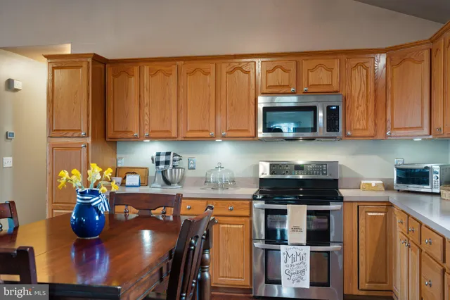 a living room with furniture chandelier and a large window