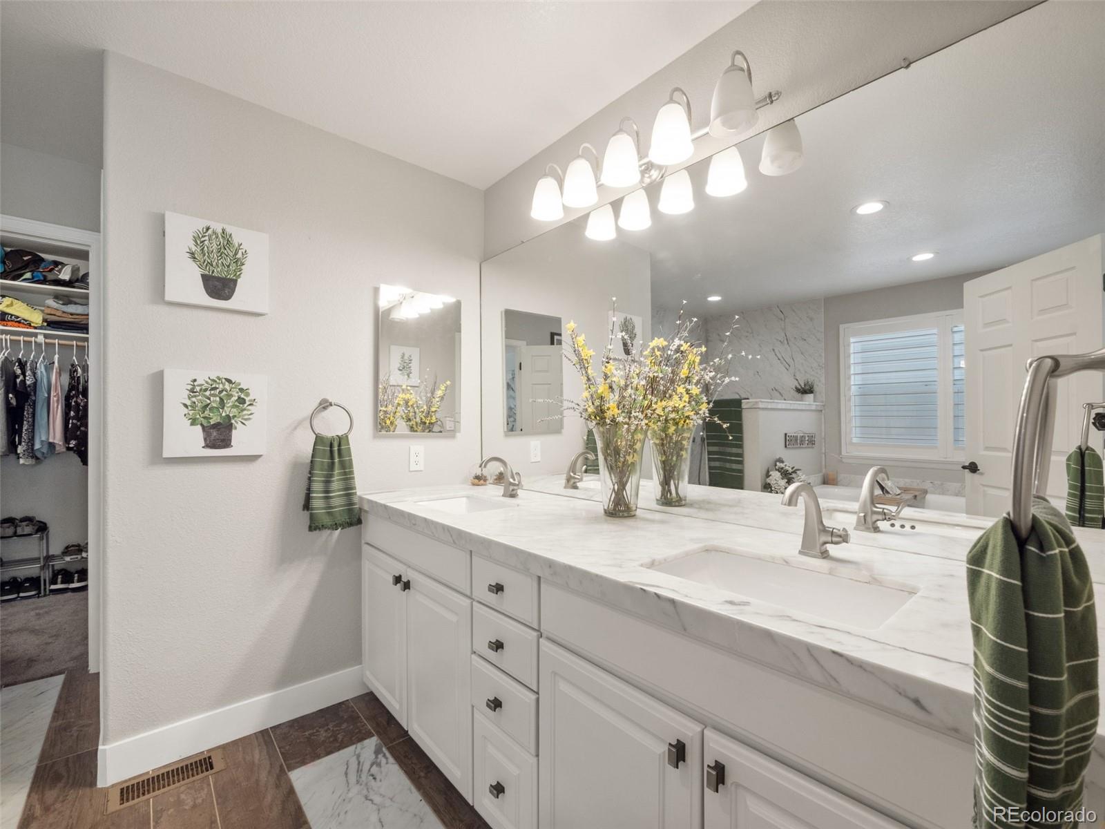 1658 Spring Water Place Highlands Ranch, CO 80129 - Photo 17 of 38 a bathroom with a double vanity sink and a mirror