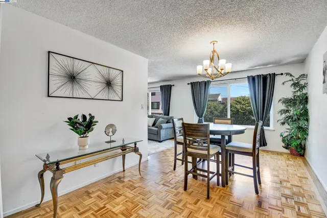 a view of a dining room with furniture and chandelier