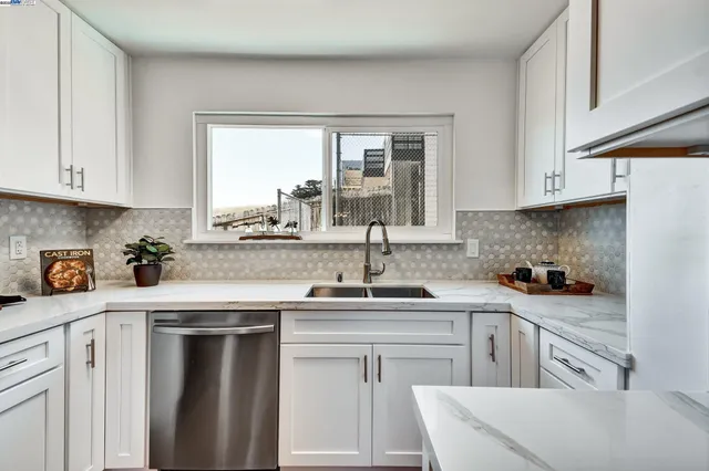 a kitchen with a sink stove and cabinets