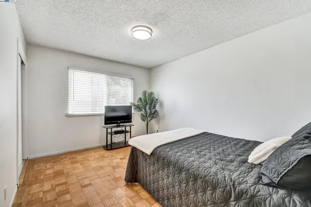 a bedroom with a bed television with the outer view