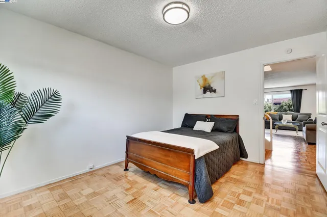 a spacious bedroom with a bed and a couch