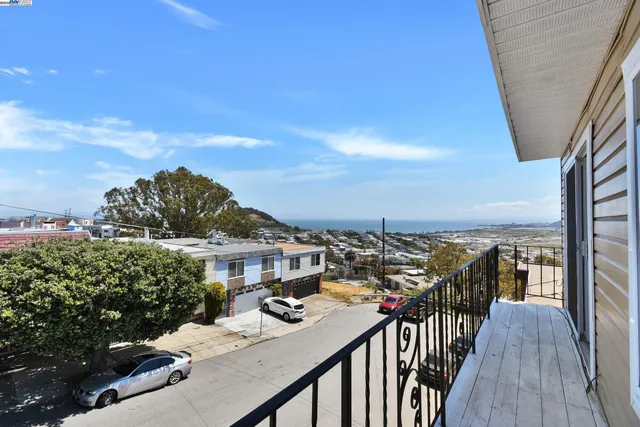 a view of a balcony with wooden floor and city view