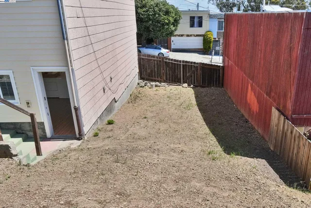 a view of a backyard with sitting area