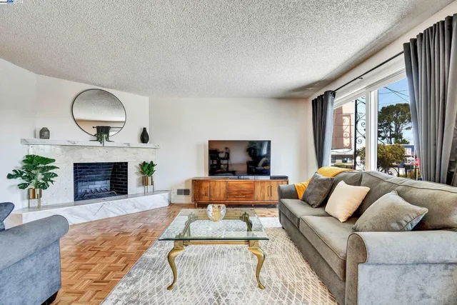 a living room with furniture fireplace and window