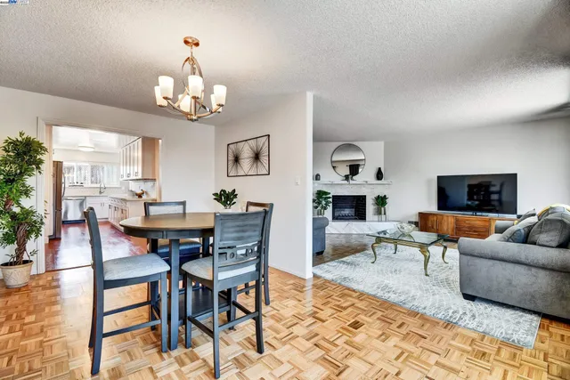 a living room with furniture a dining table and a fireplace