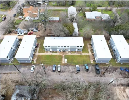an aerial view of a house with a garden and lake view