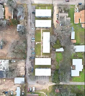 a aerial view of a residential apartment building with a yard