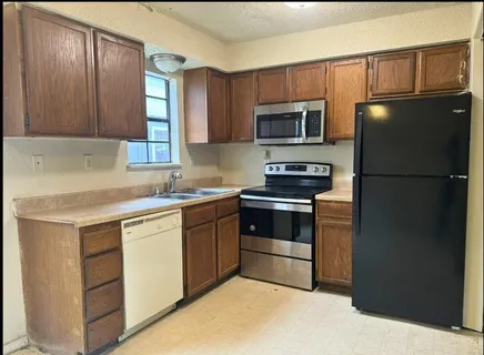 a kitchen with a refrigerator stove and microwave