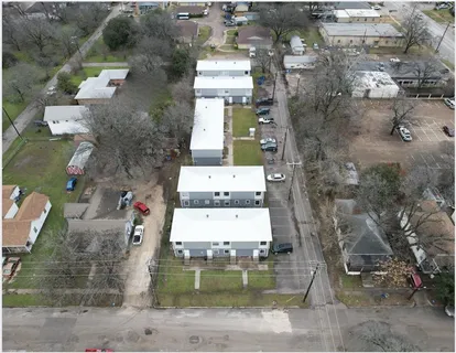 an aerial view of residential houses with outdoor space