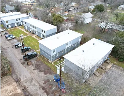 an aerial view of a house with swimming pool and outdoor seating