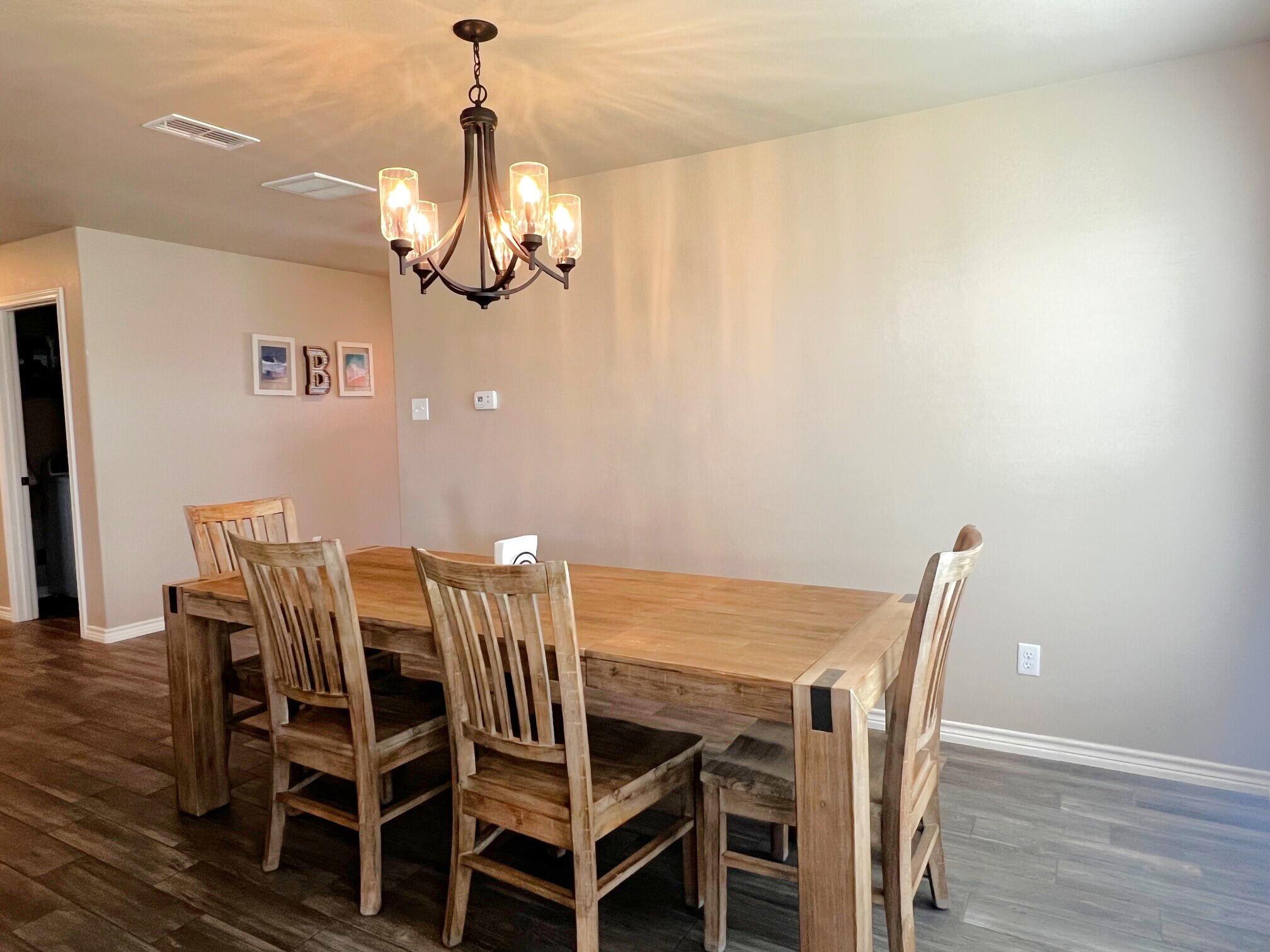 8803 10th Place Lubbock, TX 79416 - Photo 11 of 27 a view of a dining room with furniture and wooden floor