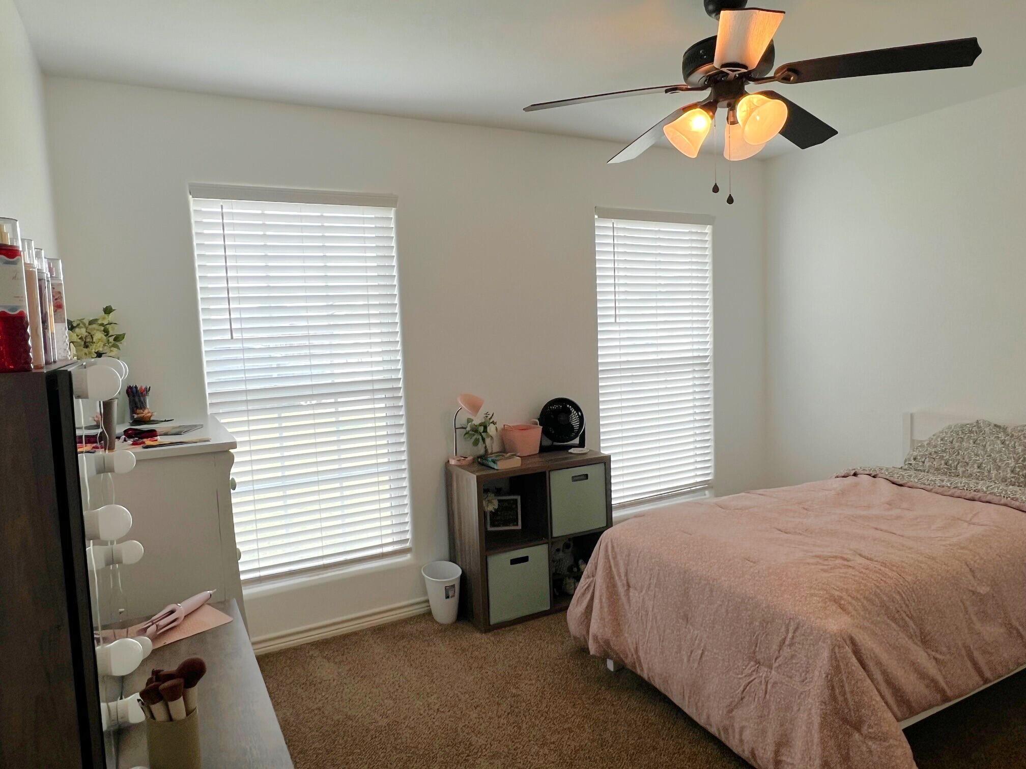 8803 10th Place Lubbock, TX 79416 - Photo 20 of 27 a bedroom with a bed and a window