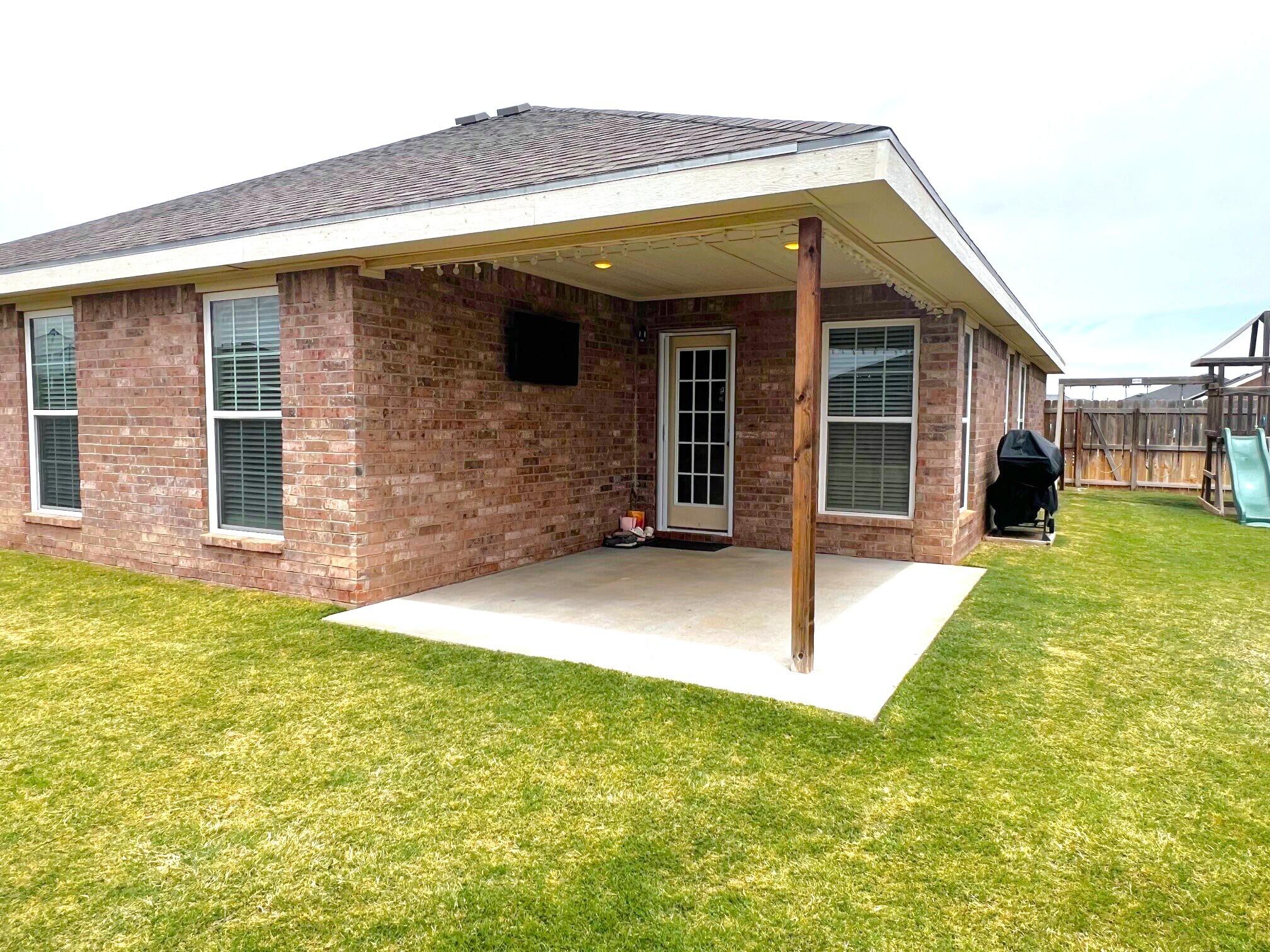 8803 10th Place Lubbock, TX 79416 - Photo 23 of 27 a view of a house with a backyard