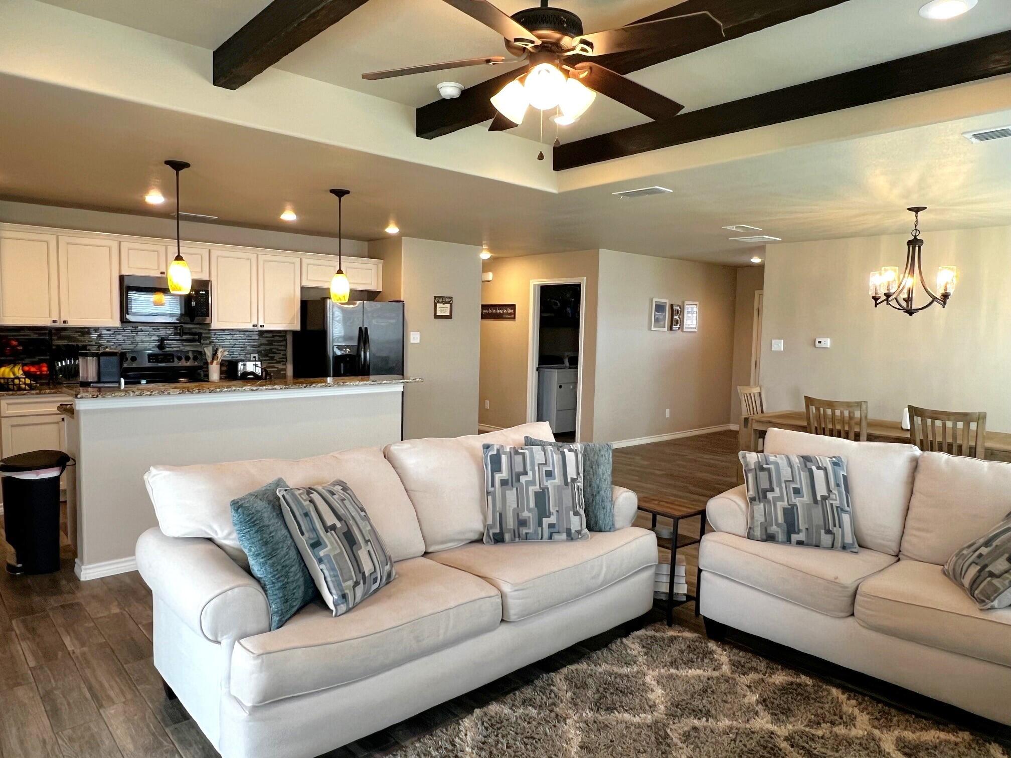 8803 10th Place Lubbock, TX 79416 - Photo 3 of 27 a living room with furniture and kitchen view