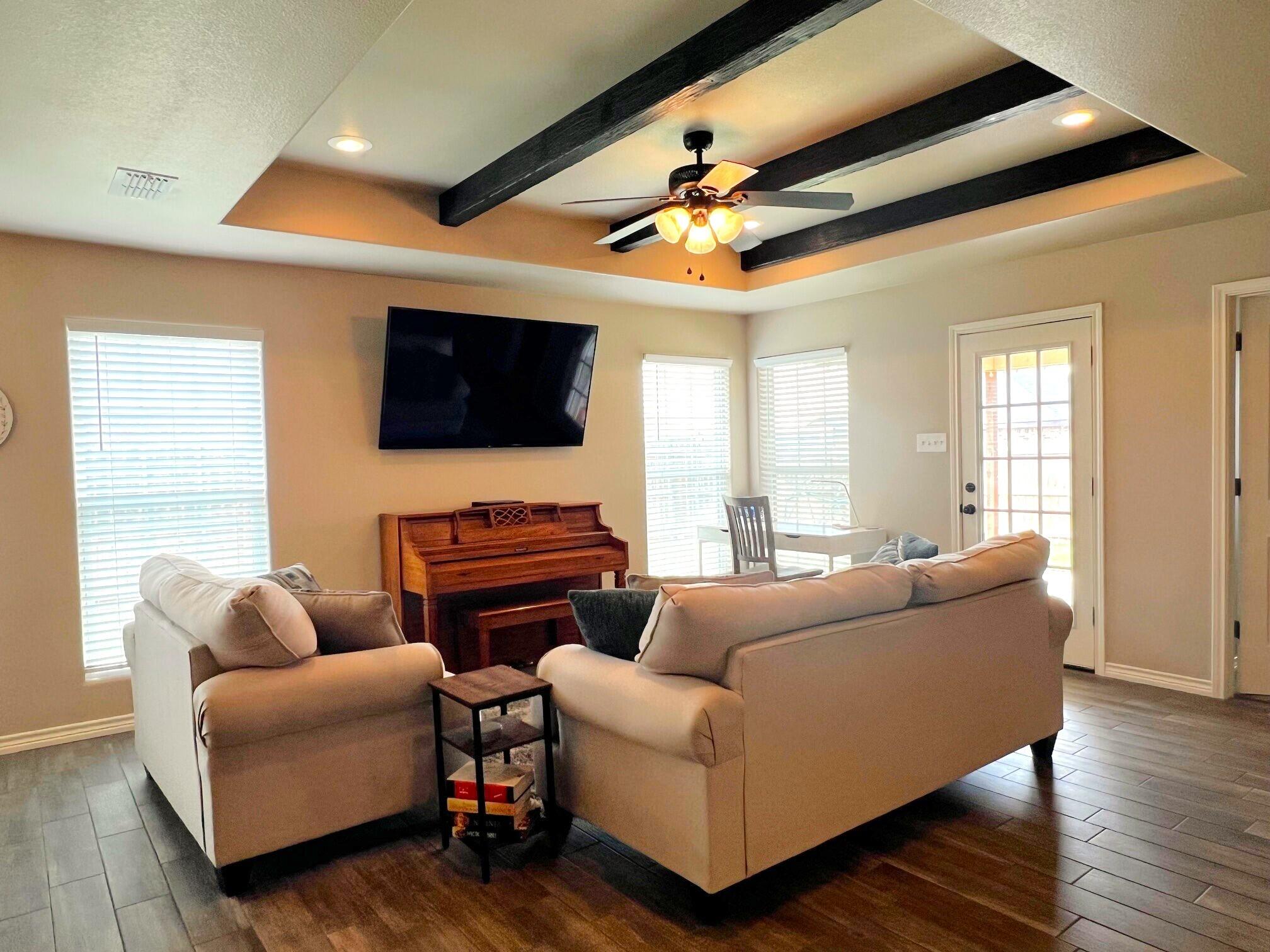 8803 10th Place Lubbock, TX 79416 - Photo 7 of 27 a living room with furniture and a flat screen tv