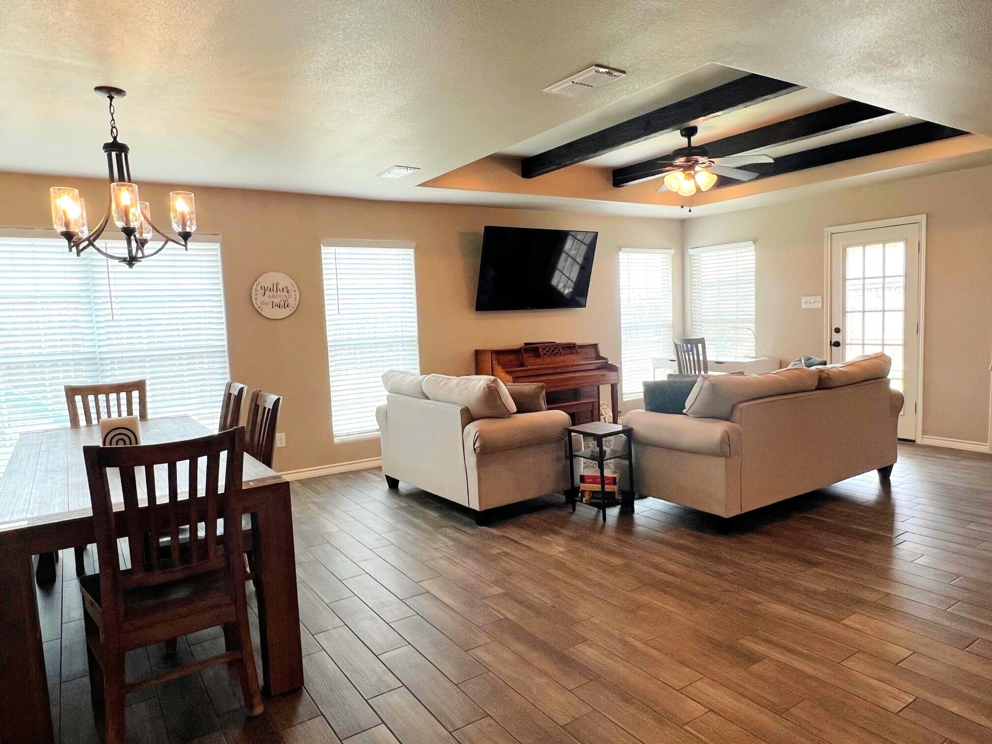 8803 10th Place Lubbock, TX 79416 - Photo 8 of 27 a living room with furniture and a wooden floor