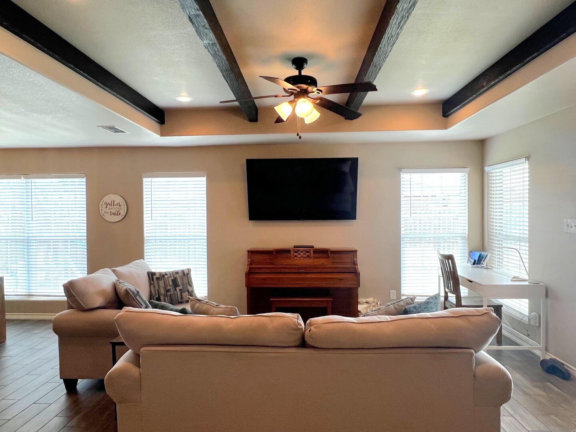 8803 10th Place Lubbock, TX 79416 - Photo 9 of 27 a living room with furniture and a flat screen tv