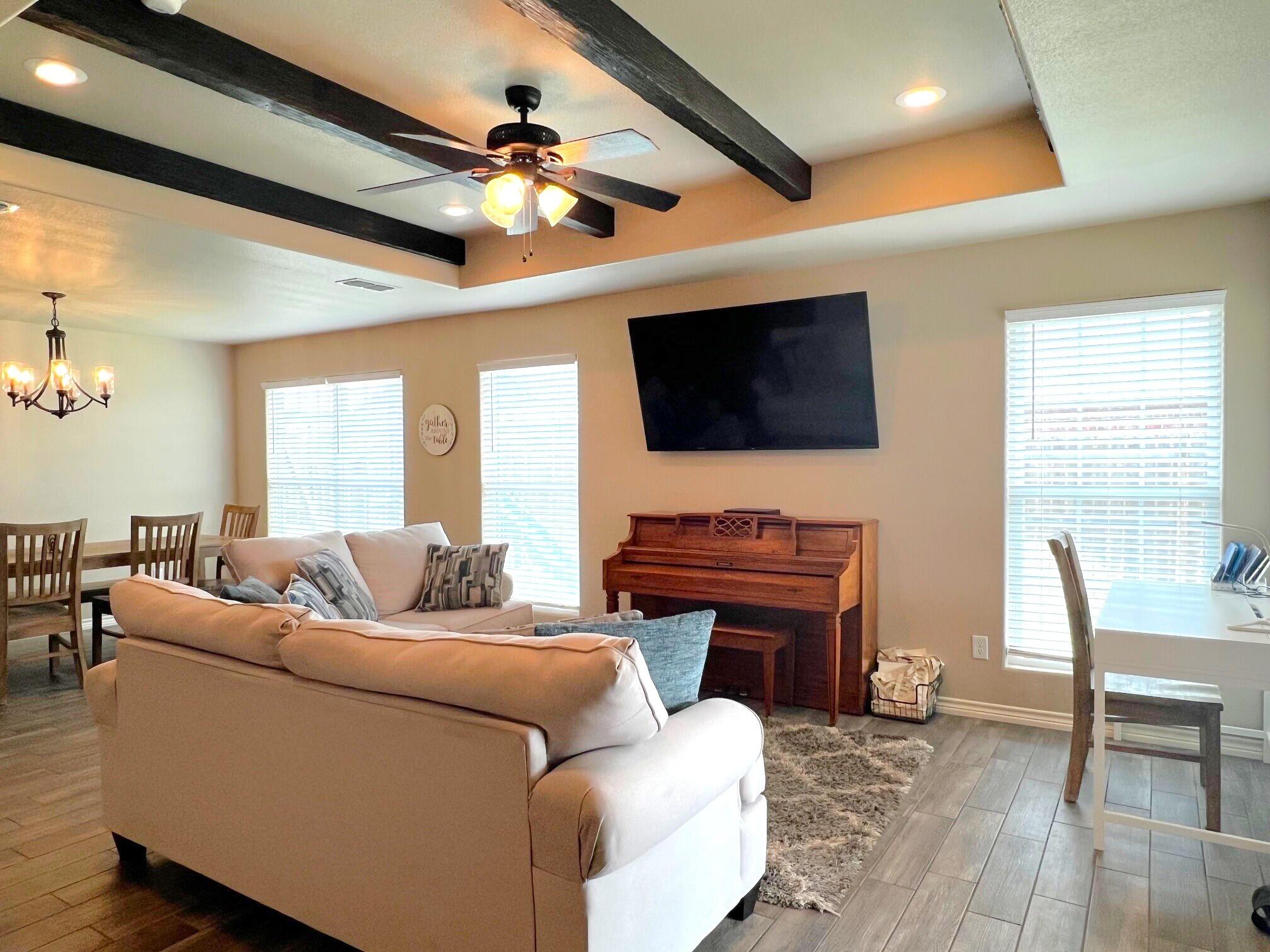 8803 10th Place Lubbock, TX 79416 - Photo 10 of 27 a living room with furniture and a flat screen tv