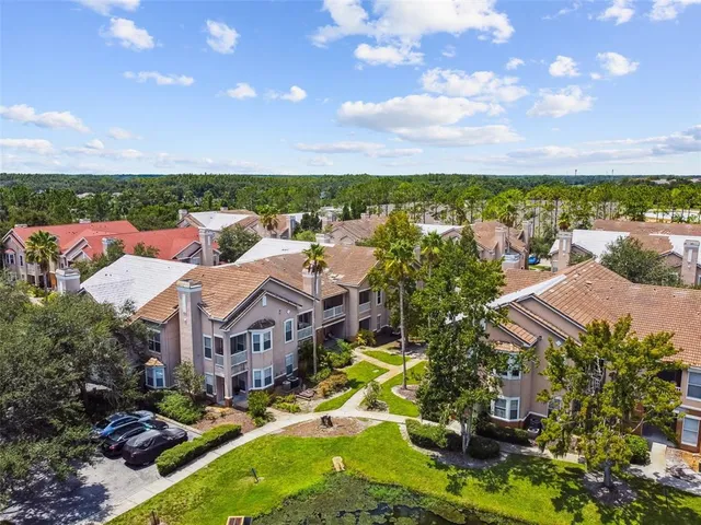a view of a house with swimming pool and a yard